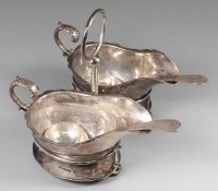 A pair of George V gravy boats, stand and ladles, maker J.T & Co, Sheffield, 1921 of plain form with