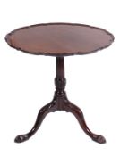 A Georgian mahogany circular pie crust tea table, the snap top with a moulded edge on fluted and