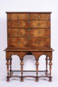 A late 17th/early 18th Century walnut and feather banded chest on a later stand, the upper part with
