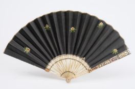 An late 18th century ivory and mother-of-pearl fan, the black silk leaf with embroidered flowerheads