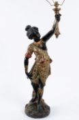 A wood, gesso and polychrome decorated female Blackamoor figure in traditional costume holding a