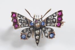A late 19th century gold, ruby, sapphire, pearl and diamond butterfly brooch approximately 35mm