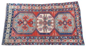 A Kazak Lori Pambak rug, the red field with triple octagonal hooked medallions with cruciform and