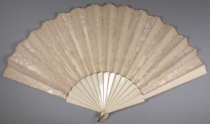 A 19th century bone and ivory fan, the silk and gauze leaf with applied lace decoration, 34.5cm.