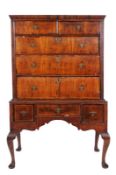 An early 18th Century walnut and inlaid chest on stand, with oak sides, decorated with lines, the