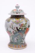 A Chinese baluster vase and cover decorated in bright enamel colours with phoenix amongst peony