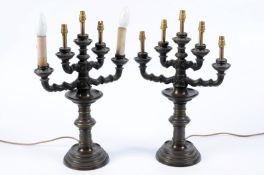 A pair of bronze four branch candelabra each with triple knopped branches with circular sconces,