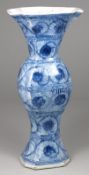 A Chinese porcelain vase of square baluster form painted in blue with bands of stylised flowers on a