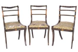 A set of six Regency simulated rosewood and decorated dining chairs, heightened with green and