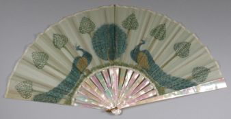 An early 20th century mother of pearl fan of Art Nouveau influence, the silk leaf decorated with