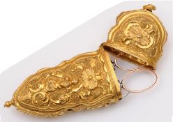 A late 18th Century gilt metal etui with scroll and foliate decoration, containing a pair of