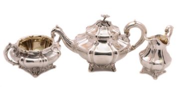 A matched 19th century silver tea service of octagonal, lobed and tapering form, with scroll
