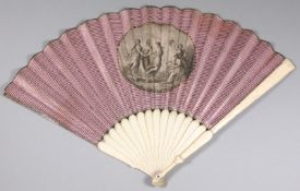 A Regency bone and ivory fan, the paper leaf with striped purple background and central cartouche