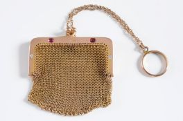 A 9ct gold, diamond and ruby mounted mesh link purse the clasp inset with two cushion-shaped