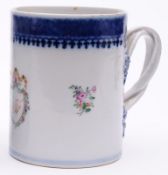 A Chinese cylindrical mug with interlocking strap handle, decorated in famille rose enamels with
