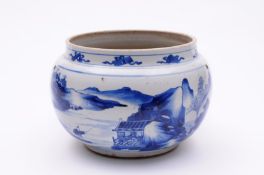 A Chinese porcelain bowl of squat form painted in blue with a panel containing a flying crane and