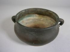 A Chinese bronze censer of squat baluster circular form with plain loop handles, bears six character