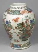 A Chinese-style famille verte baluster vase painted with butterflies and large baskets of flowers,