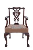 A George III carved mahogany elbow chair, the back with shaped rope tied and tassel hung top rail