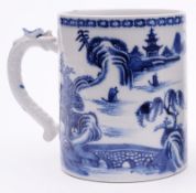 A Chinese blue and white mug with dragon handle, painted with figures and pagodas in an extensive