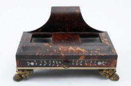An early 19th Century tortoiseshell inkstand. of rectangular outline, with scroll back, pen tray and