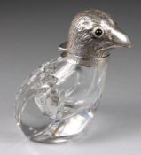 A clear glass and white metal mounted scent bottle in the form of a bird, the hinged head with inset