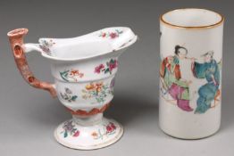 A Chinese famille rose ‘monk’s cap’ cream jug with branch handle, painted with bands of lotus,