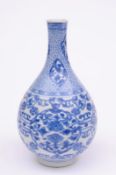A Chinese porcelain vase for the Japanese market of pear shaped form and painted in blue with four