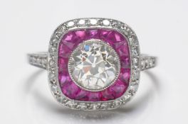 An art deco-style diamond and ruby cushion-shaped cluster ring with central round old brilliant-