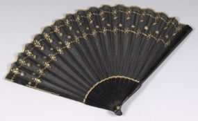 A 19th century black silk fan, the leaf with applied sequin decoration, having ebonised guards,