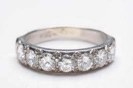 A platinum and diamond mounted half-eternity ring with seven circular brilliant-cut diamonds