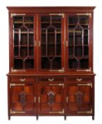 Maple & Co Ltd-A mahogany bookcase in the Aesthetic movement taste, with pierced brass strap