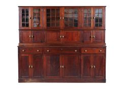 A mahogany kitchen dresser, the upper part enclosed by three pairs of glazed panel doors with