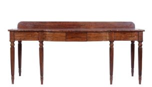 An early 19th Century mahogany breakfront rectangular serving table, the top with a ledge back,