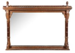 A late Victorian Gothic oak and inlaid overmantel, of large size with a dentil cornice and leaf
