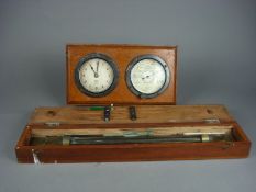 A Short and Mason`s Tycos time keeper and stormoguide on an oak plinth and a cased brass rolling