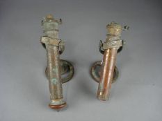 A pair of brass gimbaled cabin lights, having spring loaded candle holders on circular mounts (one