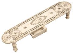A late 18th/early 19th Century prisoner of war bone cribbage board, with heart and laurel wreath