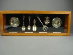 A collection of enamel ships spoons and ashtrays most notably HMS Hood pickle fork, also including