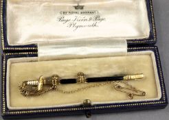 A 15ct gold and enamel stick pin in the form of a Royal Naval officers dress sword, in a blue