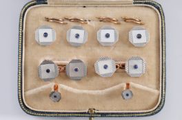 A suite of 18ct gold, mother of pearl and sapphire cuff links, buttons and dress studs each with
