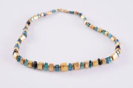 Charmian Harris. An 18ct gold and tourmaline bead single-string necklace with graduated greenish