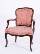A carved beechwood open armchair in the French Hepplewhite taste the moulded cartouche shaped