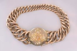 An early 20th century gold graduated curb-link bracelet with circular locket clasp decorated with
