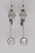 A pair of diamond pendant earrings each with a cushion-shaped, old brilliant-cut diamond