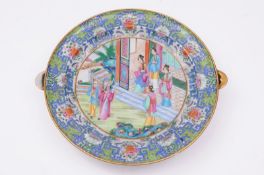 A Canton famille rose warming dish decorated with elegant ladies and other figures outside a