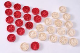 A set of thirty two Chinese carved ivory draughts pieces one side stained red the other side left