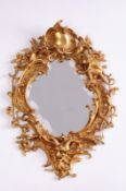 A 19th century gilt brass wall mirror, the central shaped bevelled mirror plate with pierced foliate