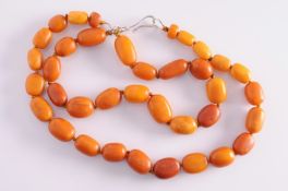 A graduated amber beaded single string necklace, together with a matching necklace.