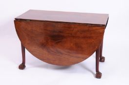 A mid 18th century mahogany dropflap dining table, the hinged top with D-shaped leaves on tapered
